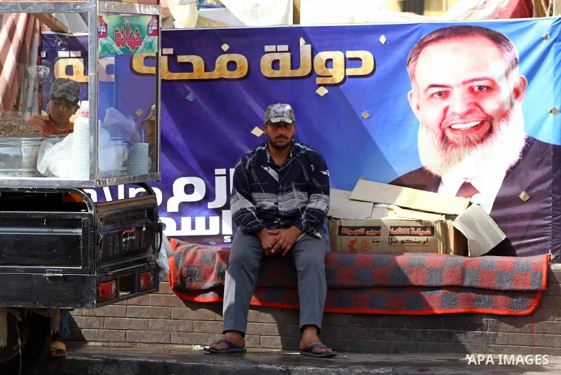 Egyptian youth sets in front of portrait for former presidential candidate Hazem Salah Abu Ismail at Tahrir Square in Cairo May 01, 2012. Egyptians demanded that their military rulers pledge to hand over power by mid-yea...
