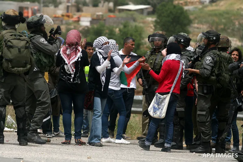 Palestinian women shout slogans against Israeli troops outside Ofer military prison near the West Bank city of Ramallah on May 1, 2012 during a demonstration in support for prisoners held in Israeli jails. Clashes erupte...