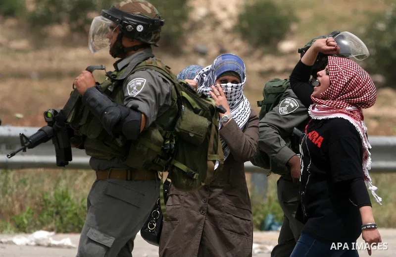 Palestinian women shout slogans against Israeli troops outside Ofer military prison near the West Bank city of Ramallah on May 1, 2012 during a demonstration in support for prisoners held in Israeli jails. Clashes erupte...