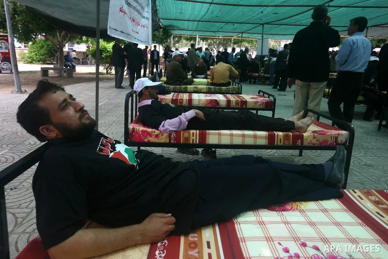 Palestinians participat at hunger striking during a rally held by hunger striking activists in solidarity with Palestinians prisoners held in Israeli jails, in Gaza City, Wednesday, May 2, 2012. A Palestinian rights grou...