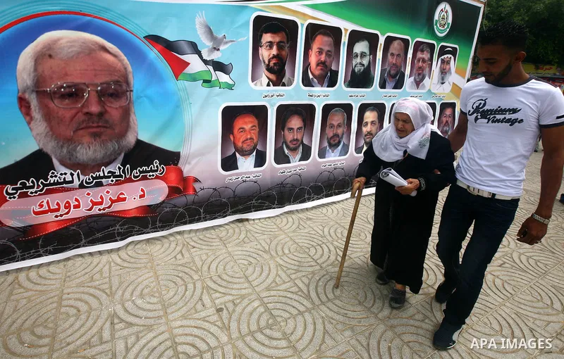 Palestinians look at posters of Palestinian prisoners, during a rally held by hunger striking activists in solidarity with Palestinians prisoners held in Israeli jails, in Gaza City, Wednesday, May 2, 2012. A Palestinian...