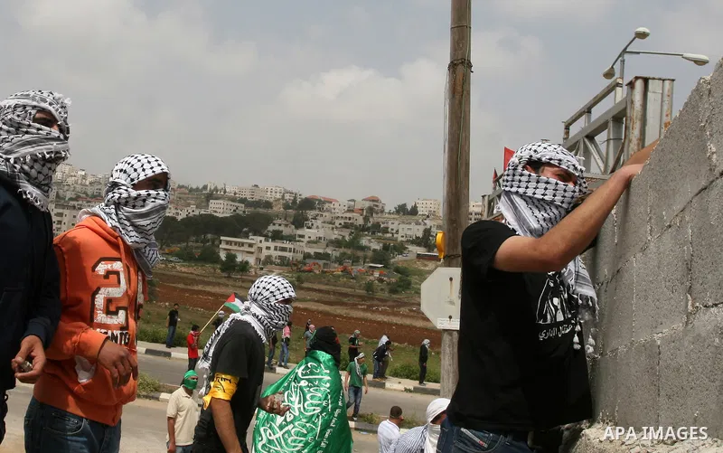 Palestinians throw stones at Israeli soldiers during clashes next to the Israeli military prison of Ofer, near Beitunia, West Bank, 02 May 2012. The protesters were protesting in solidarity with the Palestinian prisoners...