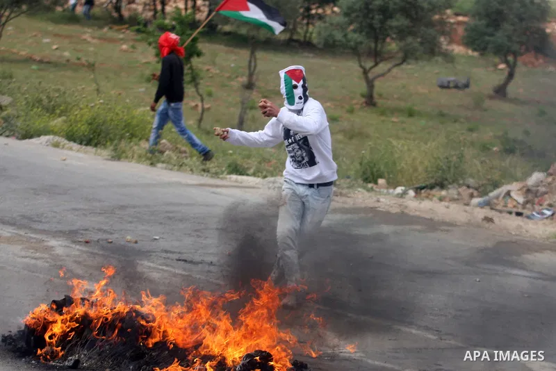 Palestinians throw stones at Israeli soldiers during clashes next to the Israeli military prison of Ofer, near Beitunia, West Bank, 02 May 2012. The protesters were protesting in solidarity with the Palestinian prisoners...