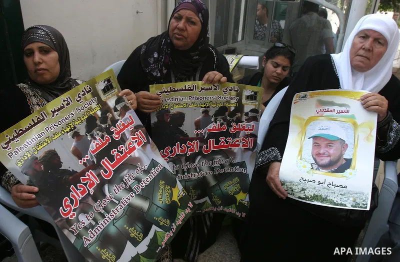 Palestinian protesters hold up banners and portraits of a prisoners jailed in Israel, during a Sit-in held outside the International Committee of the Red Cross (ICRC) in the West Bank, city of Jerusalem, May 02, 2012. Ov...