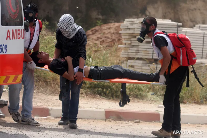 A Palestinian protester chokes from tear gas fired by Israeli troops during clashes next to the Israeli military prison of Ofer, near Beitunia, West Bank, 02 May 2012. The protesters were protesting in solidarity with th...