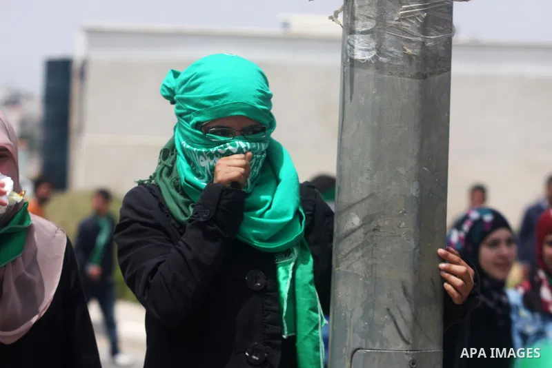 A Palestinian protester chokes from tear gas fired by Israeli troops during clashes next to the Israeli military prison of Ofer, near Beitunia, West Bank, 02 May 2012. The protesters were protesting in solidarity with th...