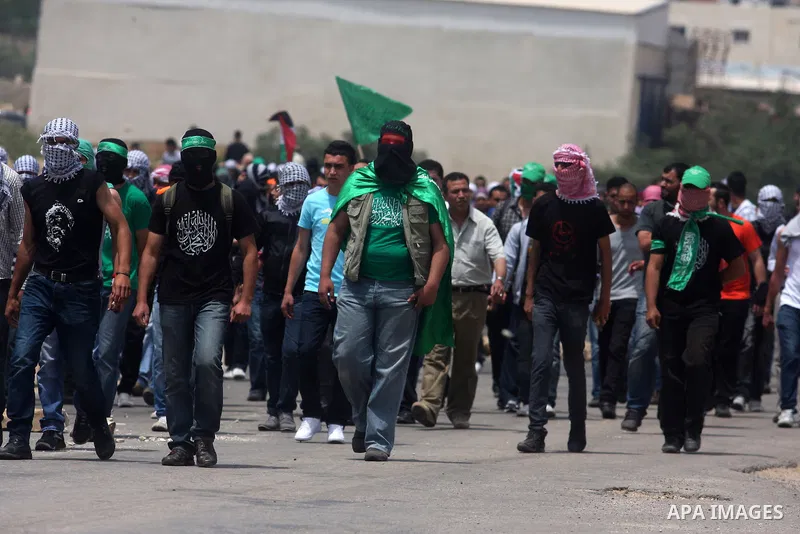 Palestinians throw stones at Israeli soldiers during clashes next to the Israeli military prison of Ofer, near Beitunia, West Bank, 02 May 2012. The protesters were protesting in solidarity with the Palestinian prisoners...