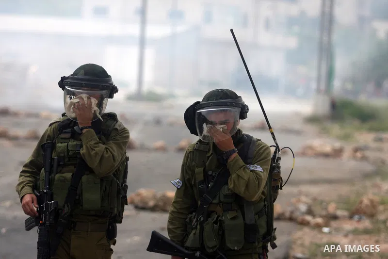 Israeli troops fired tear gas fired near Palestinian stone-throwers during clashes next to the Israeli military prison of Ofer, near Beitunia, West Bank, 02 May 2012. The protesters were protesting in solidarity with the...
