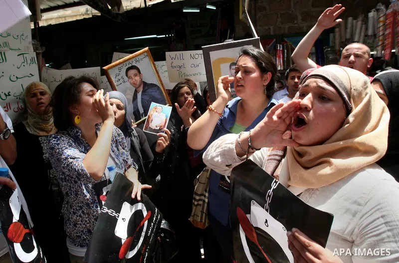 Palestinian protesters hold up pictures and portraits of a prisoners jailed in Israel, during a rally in solidarity with prisoners in Israeli jails, in the West Bank city of Nablus, 03 May, 2012. Over 1,350 Palestinian p...