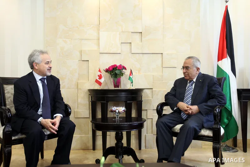 Palestinian Prime Minister Salam Fayyad, meets with Deputy Foreign Minister of Canada, Mr. Morris Rosenberg, in the West Bank City of Ramallah, on May 03, 2012. Photo by Mustafa Abu Dayeh