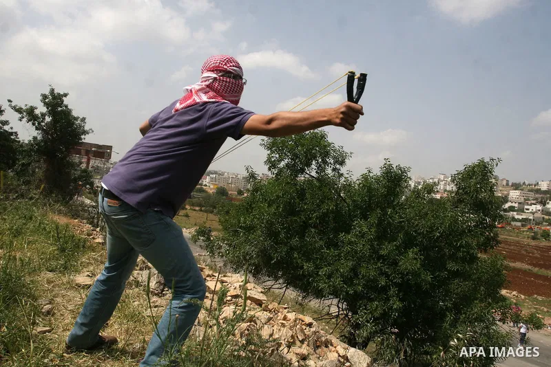 Palestinians throw stones at Israeli soldiers during clashes next to the Israeli military prison of Ofer, near Beitunia, West Bank, 02 May 2012. following a demonstration in solidarity with Palestinian prisoners held in...