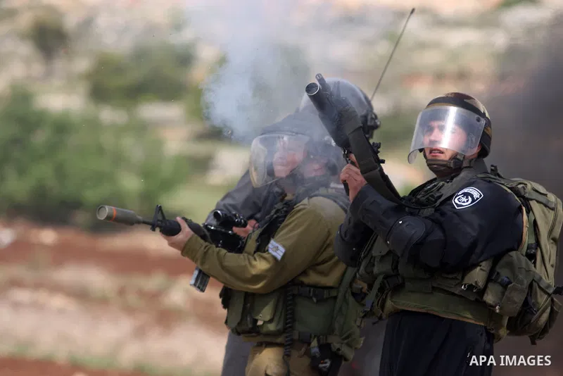 Israeli troops fire tear gas and rubber bullets towards Palestinian stone-throwers during clashes next to the Israeli military prison of Ofer, near Beitunia, West Bank, 03 May 2012. following a demonstration in solidarit...