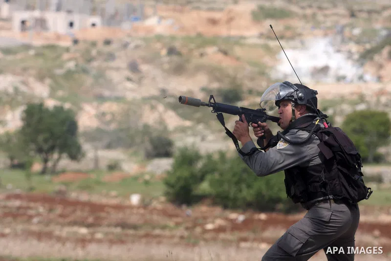 Israeli troops fire tear gas and rubber bullets towards Palestinian stone-throwers during clashes next to the Israeli military prison of Ofer, near Beitunia, West Bank, 03 May 2012. following a demonstration in solidarit...