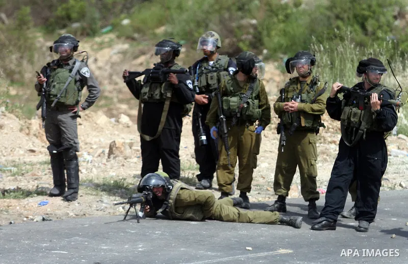 Israeli troops fire tear gas and rubber bullets towards Palestinian stone-throwers during clashes next to the Israeli military prison of Ofer, near Beitunia, West Bank, 03 May 2012. following a demonstration in solidarit...