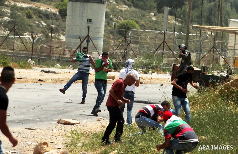 Palestinians throw stones at Israeli soldiers during clashes next to the Israeli military prison of Ofer, near Beitunia, West Bank, 02 May 2012. following a demonstration in solidarity with Palestinian prisoners held in...