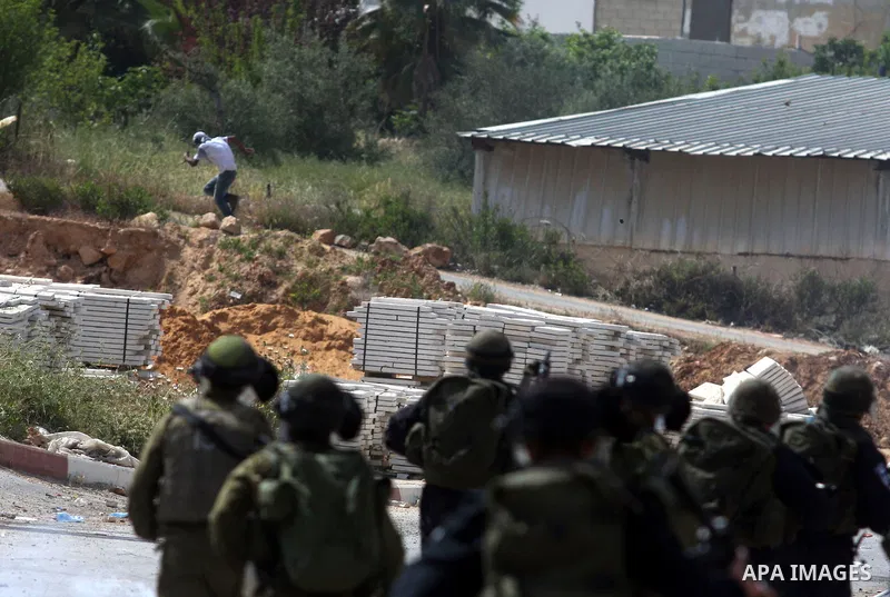 Israeli troops fire tear gas and rubber bullets towards Palestinian stone-throwers during clashes next to the Israeli military prison of Ofer, near Beitunia, West Bank, 03 May 2012. following a demonstration in solidarit...