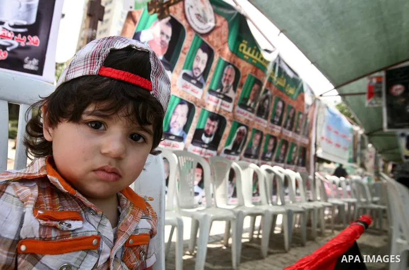 A Palestinian child participats at hunger striking during a sit-in tent held by Palestinian released prisoners, solidarity with Palestinian prisoners held in Israeli jails, in Gaza City on May 04, 2012. Photo by Ali Jada...