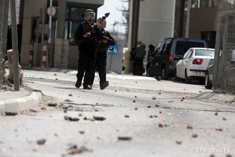 Israeli troops fire tear gas and rubber bullets towards Palestinian stone-throwers during clashes with Palestinian stone-throwers in Qalandia in the occupied West Bank, following a demonstration on May 4, 2012 solidarity...