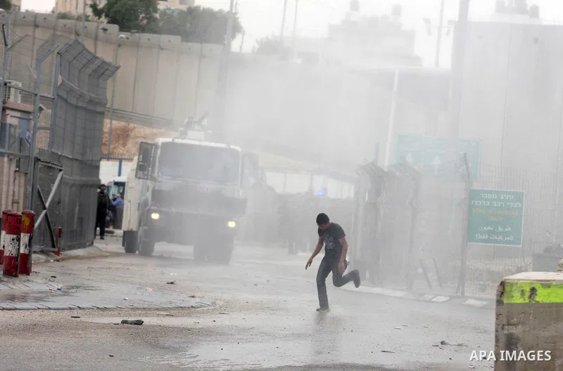 A Palestinian man throws stones at Israeli soldiers at the Qalandia crossing in the occupied West Bank during a demonstration on May 4, 2012 in solidarity with Palestinian prisoners on hunger strike to protest Israel's u...