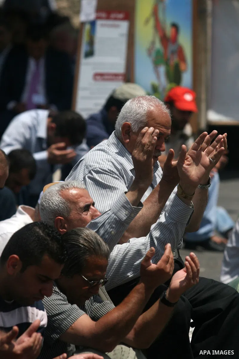 Palestinians perform Friday prayers during protest, in Ramallah, West Bank, May 04, 2012. An estimated 2,000 Palestinians held in prayer outside a tent in solidarity with prisoners who have been waging a hunger strike in...