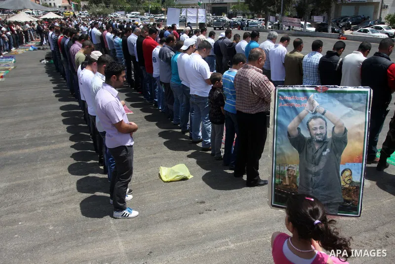 Palestinians perform Friday prayers during protest, in Ramallah, West Bank, May 04, 2012. An estimated 2,000 Palestinians held in prayer outside a tent in solidarity with prisoners who have been waging a hunger strike in...