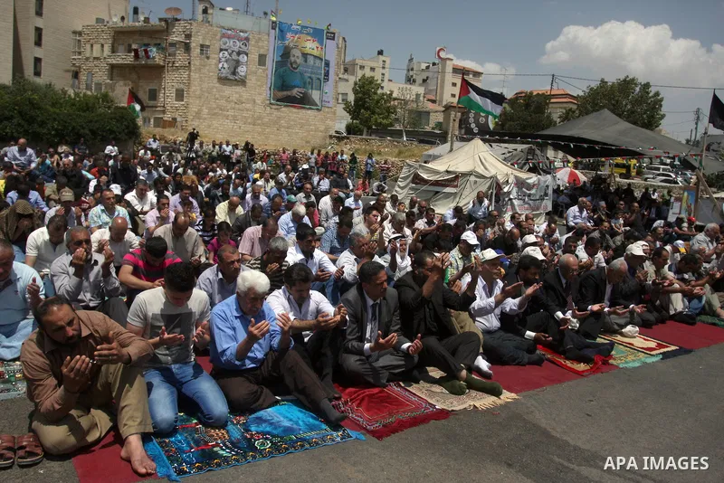 Palestinians perform Friday prayers during protest, in Ramallah, West Bank, May 04, 2012. An estimated 2,000 Palestinians held in prayer outside a tent in solidarity with prisoners who have been waging a hunger strike in...