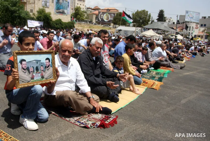 Palestinians perform Friday prayers during protest, in Ramallah, West Bank, May 04, 2012. An estimated 2,000 Palestinians held in prayer outside a tent in solidarity with prisoners who have been waging a hunger strike in...