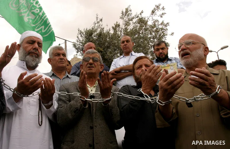 Palestinian protesters hold up banners and portraits of a prisoners jailed in Israel, during a Sit-in held in old City of Jerusalem, May 04, 2012. Over the past week, over 1400 Palestinian prisoners have begun an open-en...