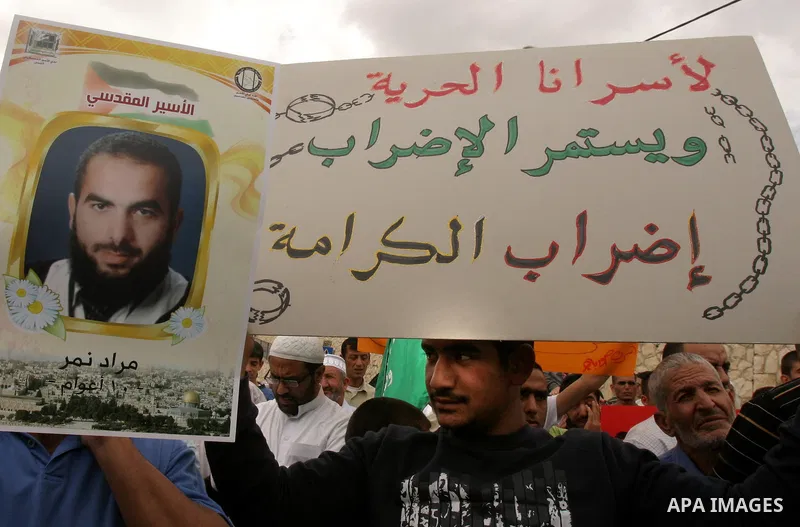 Palestinian protesters hold up banners and portraits of a prisoners jailed in Israel, during a Sit-in held in old City of Jerusalem, May 04, 2012. Over the past week, over 1400 Palestinian prisoners have begun an open-en...
