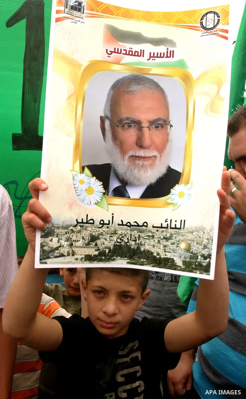 Palestinian protesters hold up banners and portraits of a prisoners jailed in Israel, during a Sit-in held in old City of Jerusalem, May 04, 2012. Over the past week, over 1400 Palestinian prisoners have begun an open-en...