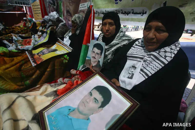 Relatives of hunger striking Palestinian inmates of Israeli prisons hold portraits during a sit-in solidarity protest in a tent, in Gaza City, Gaza Strip, on 04 May 2012. Protests continued in solidarity with hundreds of...