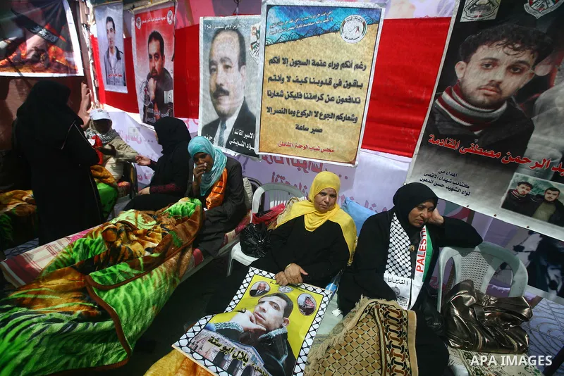 Relatives of hunger striking Palestinian inmates of Israeli prisons hold portraits during a sit-in solidarity protest in a tent, in Gaza City, Gaza Strip, on 04 May 2012. Protests continued in solidarity with hundreds of...