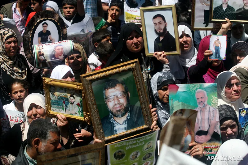 Supporters of the Islamic Hamas movement hold a rally in the West Bank city of Ramallah, calling for the release of prisoners being held in Israeli prisons on May 5, 2012, as ten Palestinian hunger strikers held at an Is...