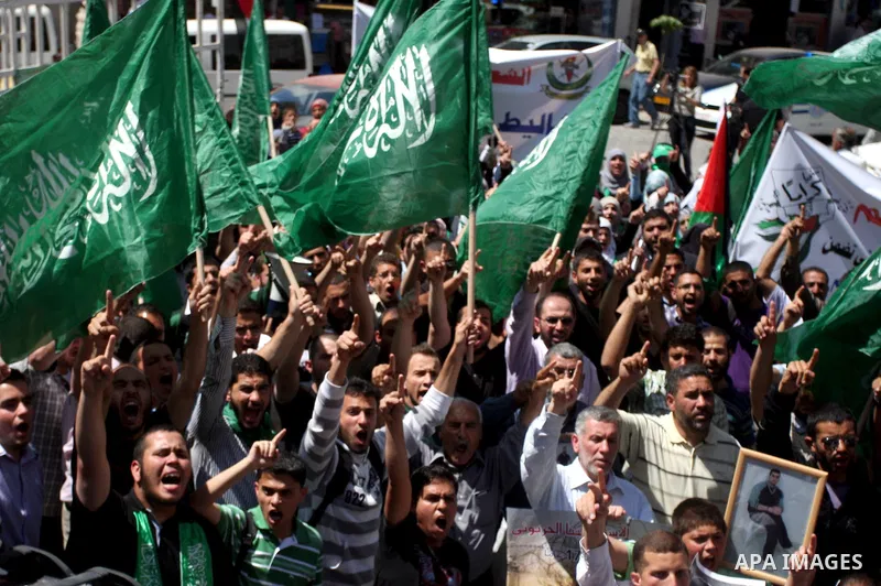 Supporters of the Islamic Hamas movement hold a rally in the West Bank city of Ramallah, calling for the release of prisoners being held in Israeli prisons on May 5, 2012, as ten Palestinian hunger strikers held at an Is...