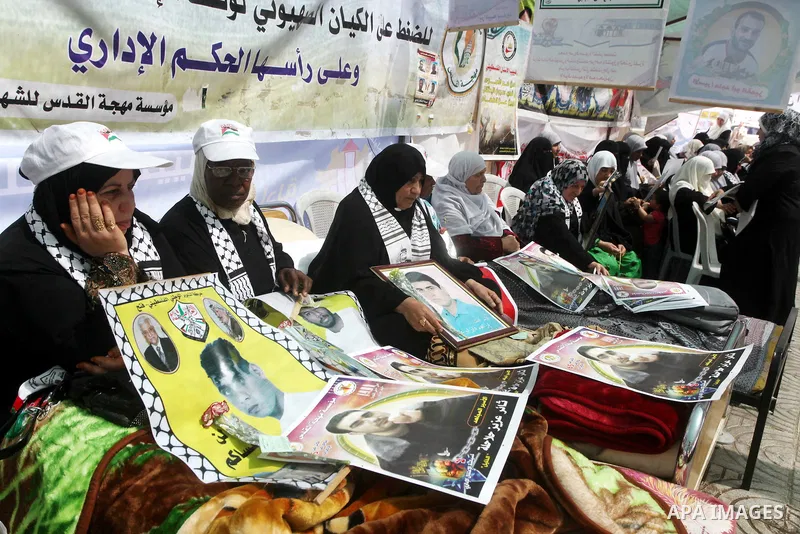 Relatives of hunger striking Palestinian inmates of Israeli prisons hold portraits during a sit-in solidarity protest in a tent, in Gaza City, Gaza Strip, on 04 May 2012. Protests continued in solidarity with hundreds of...