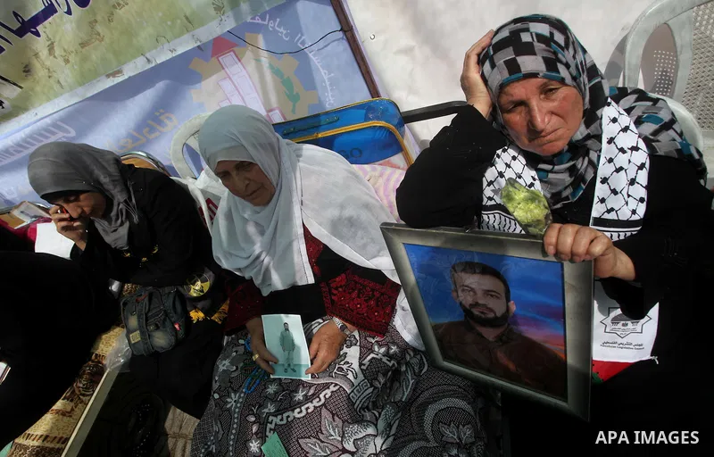 Relatives of hunger striking Palestinian inmates of Israeli prisons hold portraits during a sit-in solidarity protest in a tent, in Gaza City, Gaza Strip, on 04 May 2012. Protests continued in solidarity with hundreds of...