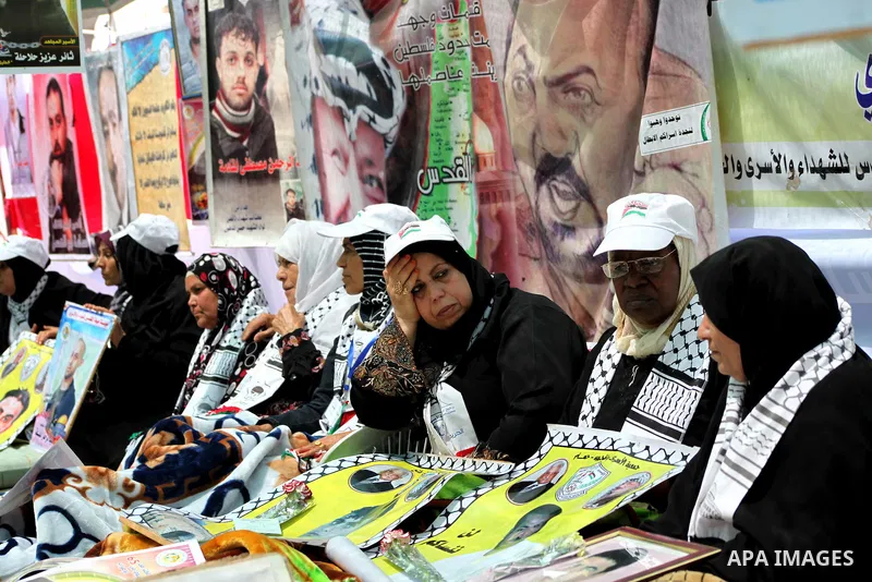 Relatives of hunger striking Palestinian inmates of Israeli prisons hold portraits during a sit-in solidarity protest in a tent, in Gaza City, Gaza Strip, on 04 May 2012. Protests continued in solidarity with hundreds of...