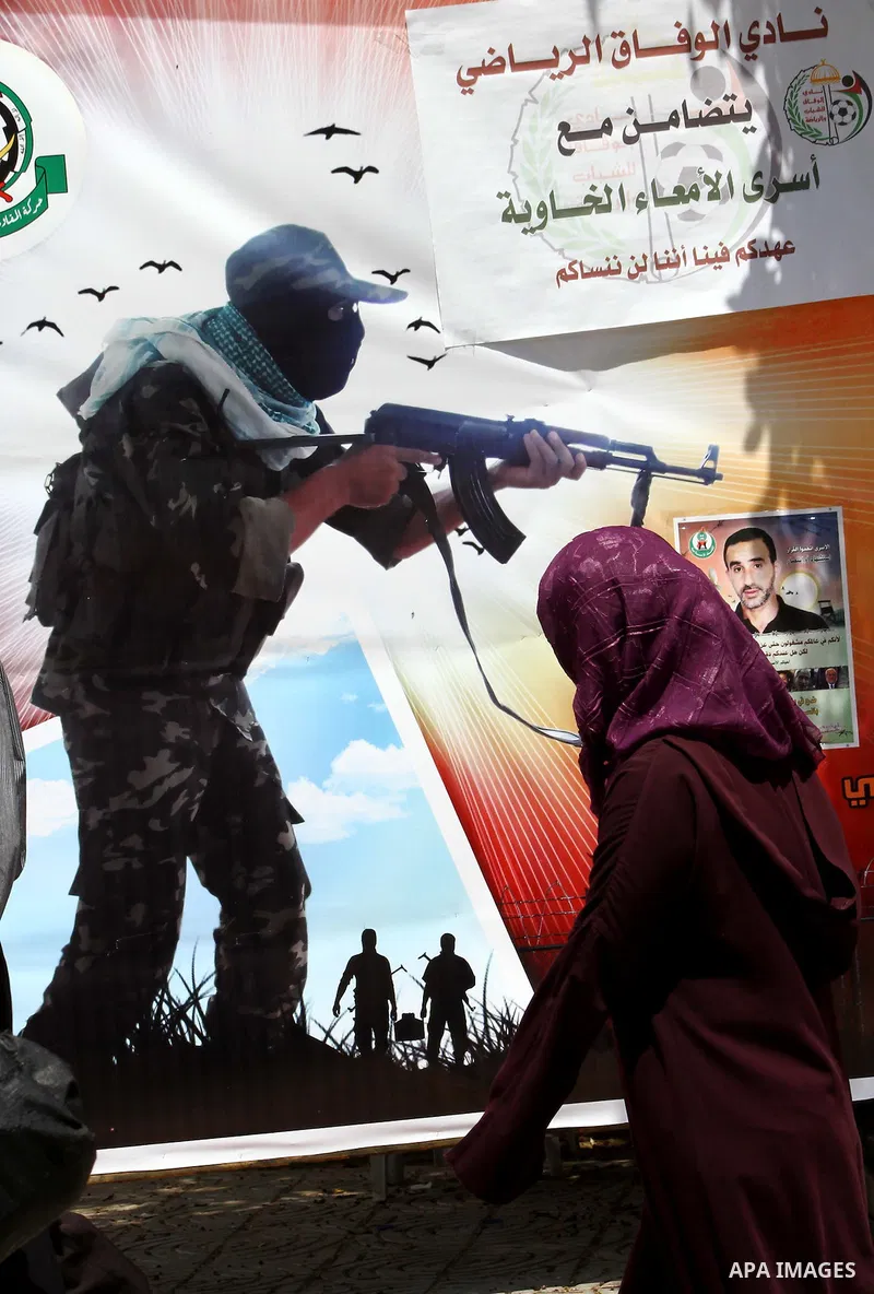 A Palestinian woman holds a framed portrait of her son, who is a prisoner in an Israeli jail, during a rally to show solidarity with prisoners held in Israeli jails, in Gaza City May 6, 2012. A hunger strike by Palestini...