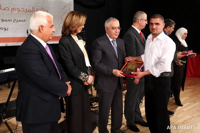 Palestinian Prime Minister, Salam Fayyad, honors students of the winners of the award late Salah Al Masri "artistic creativity", in the West Bank town of Nablus, May 6, 2012. Photo by Mustafa Abu Dayeh
