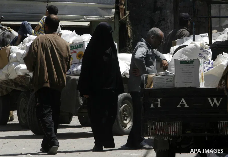 Palestinians receive monthly food aid from the United Nations Relief and Works Agency (UNRWA) center in the Rafah refugee camp, southern Gaza on May 07, 2012. The UN Agency for Palestinian Refugees (UNRWA) in Gaza launch...