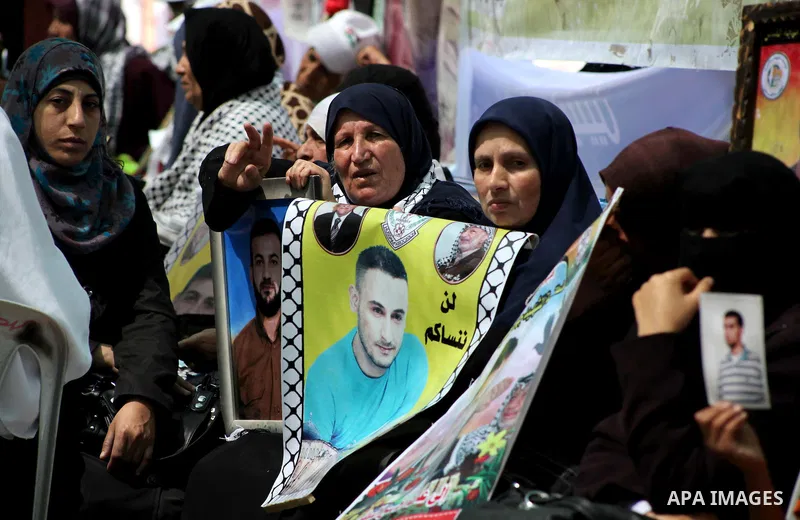 Palestinian women attend a rally in Gaza City, to show solidarity with Palestinian prisoners held in Israeli jails on May 7, 2012. At least 1,550 Palestinian prisoners are refusing food in Israeli jails in a protest agai...