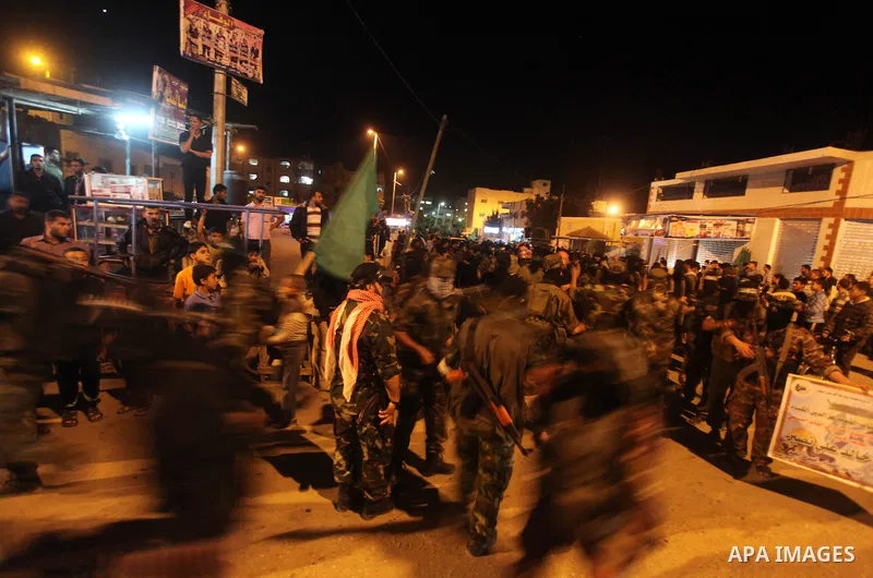 Masked Hamas militants march with their guns during a parade to show solidarity with Palestinian prisoners held in Israeli jails on May 7, 2012. At least 1,550 Palestinian prisoners are refusing food in Israeli jails in...