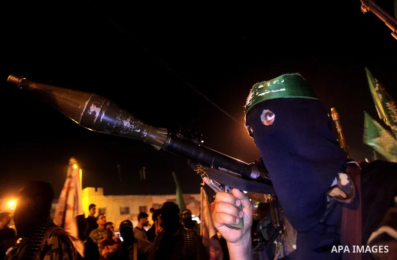 Masked Hamas militants march with their guns during a parade to show solidarity with Palestinian prisoners held in Israeli jails on May 7, 2012. At least 1,550 Palestinian prisoners are refusing food in Israeli jails in...