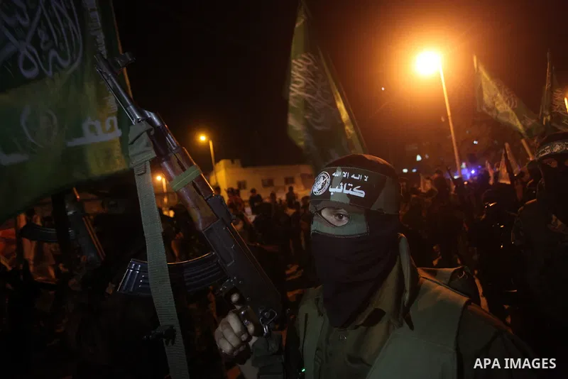Masked Hamas militants march with their guns during a parade to show solidarity with Palestinian prisoners held in Israeli jails on May 7, 2012. At least 1,550 Palestinian prisoners are refusing food in Israeli jails in...