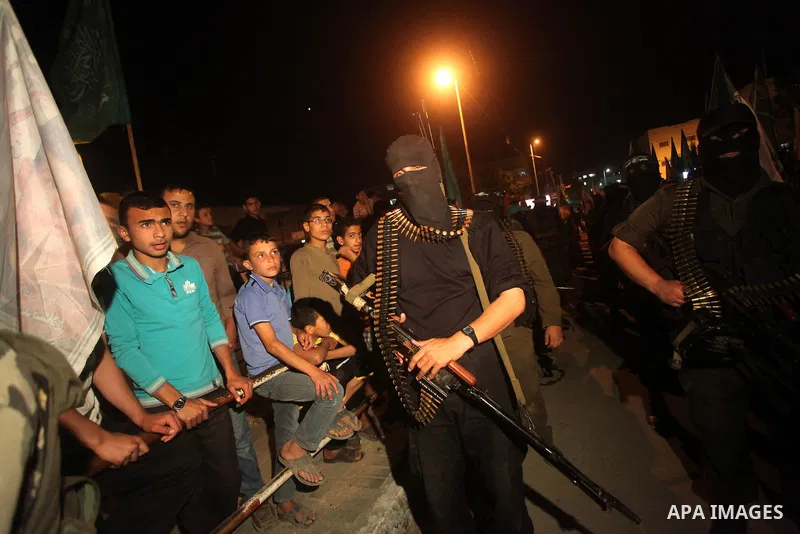 Masked Hamas militants march with their guns during a parade to show solidarity with Palestinian prisoners held in Israeli jails on May 7, 2012. At least 1,550 Palestinian prisoners are refusing food in Israeli jails in...