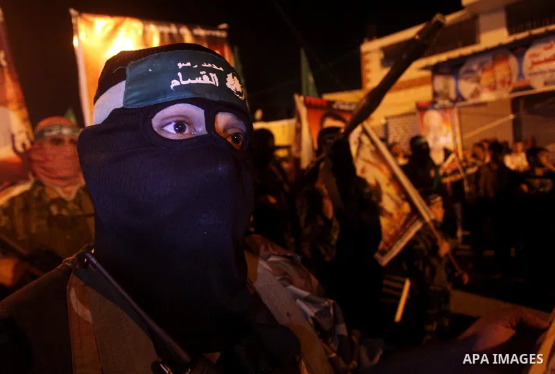 Masked Hamas militants march with their guns during a parade to show solidarity with Palestinian prisoners held in Israeli jails on May 7, 2012. At least 1,550 Palestinian prisoners are refusing food in Israeli jails in...