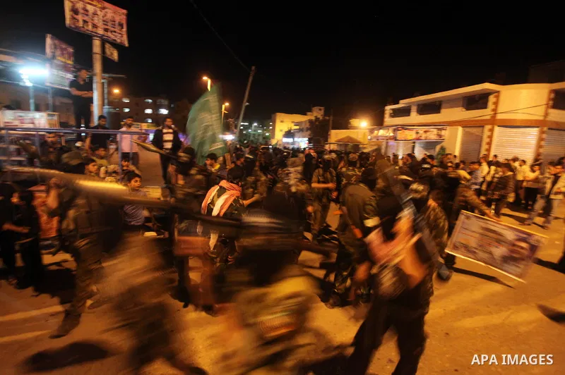 Masked Hamas militants march with their guns during a parade to show solidarity with Palestinian prisoners held in Israeli jails on May 7, 2012. At least 1,550 Palestinian prisoners are refusing food in Israeli jails in...