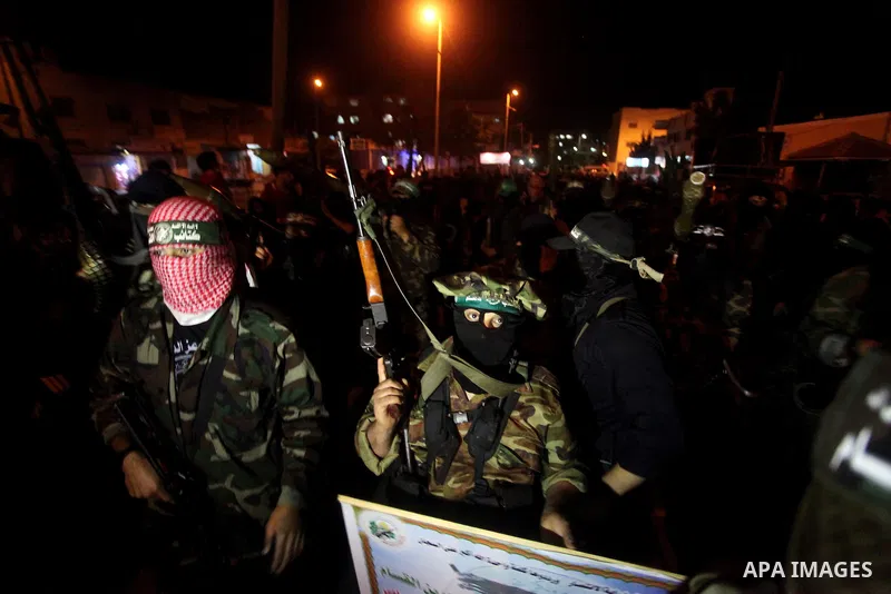 Masked Hamas militants march with their guns during a parade to show solidarity with Palestinian prisoners held in Israeli jails on May 7, 2012. At least 1,550 Palestinian prisoners are refusing food in Israeli jails in...