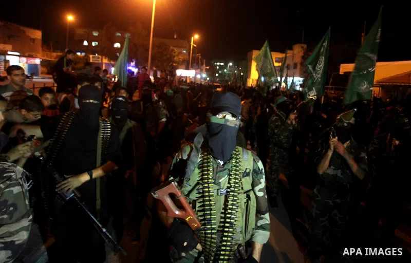 Masked Hamas militants march with their guns during a parade to show solidarity with Palestinian prisoners held in Israeli jails on May 7, 2012. At least 1,550 Palestinian prisoners are refusing food in Israeli jails in...
