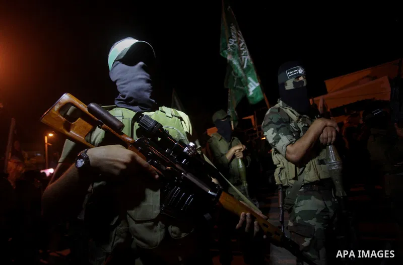 Masked Hamas militants march with their guns during a parade to show solidarity with Palestinian prisoners held in Israeli jails on May 7, 2012. At least 1,550 Palestinian prisoners are refusing food in Israeli jails in...
